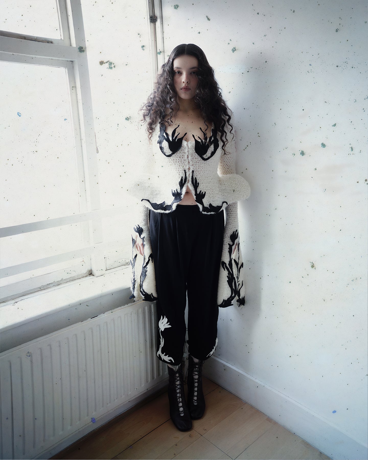Crocheted cardigan with embroidery and hook closure